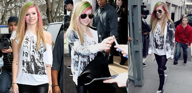 Com mechas verdes e rosas no cabelo, a cantora canadense Avril Lavigne atende fãs na saída de um hotel em Paris (8/2/2011)