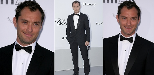 Jude Law posa para fotos ao chegar ao evento amfAR Cinema Against Aids, em Cannes (19/5/2011)