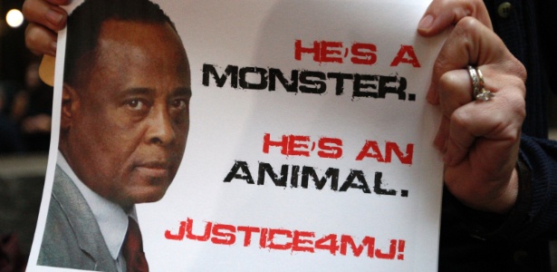 Membro do movimento "Justice 4 MJ" (Justiça para Michael, em tradução livre), segura cartaz em frente ao tribunal onde o médico será julgado (27/9/11) 