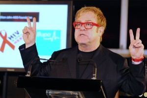Elton John faz sinal de "paz e amor" no Dia Mundial de Luta Contra a Aids, em Sydney (1º/12/11) - AFP