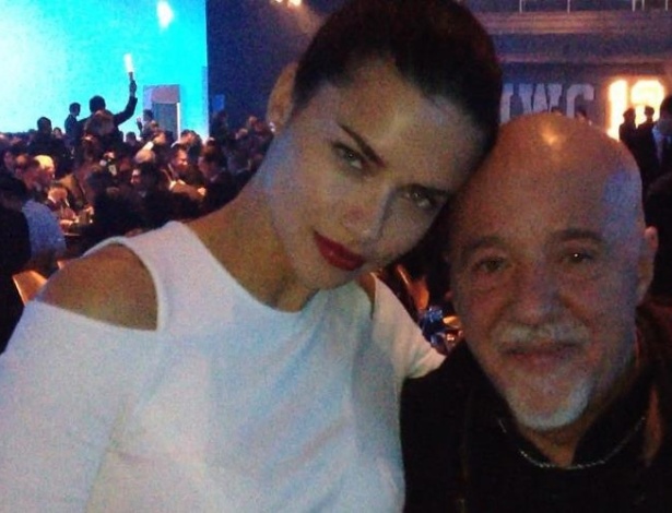 Adriana Lima posa ao lado de Paulo Coelho durante festa promovida por marca de relógio (18/1/12)