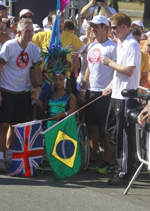 Com uma bandeira do Brasil nas mãos, Harry prepara-se para dar a largada da corrida beneficente (10/3/12)
